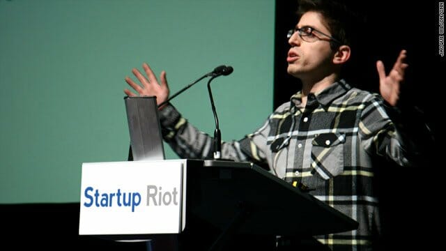 Adam Geller at podium speaking at Startup Riot