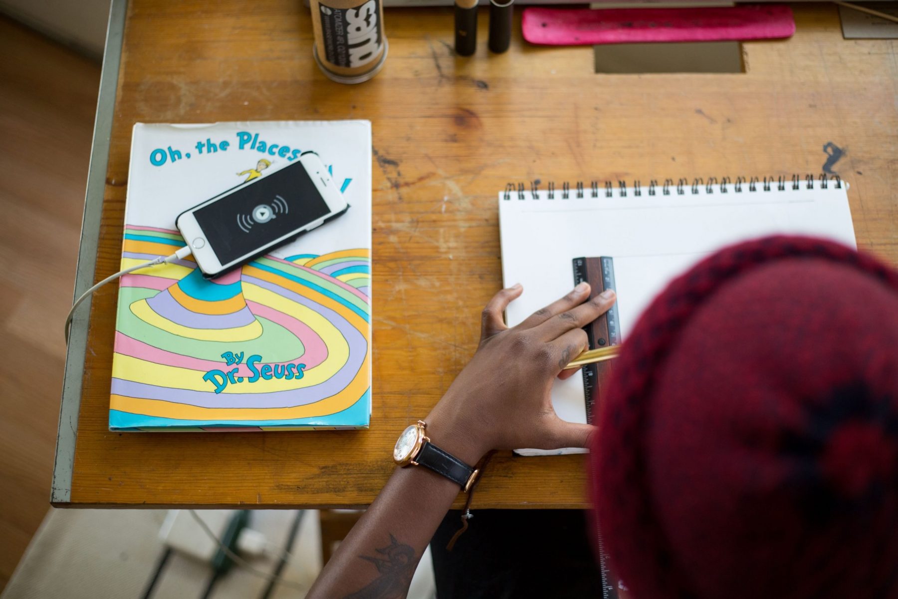 person drawing on white sketch pad for post about student independent learning