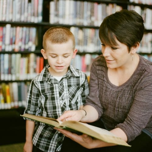 women reading a book to a child