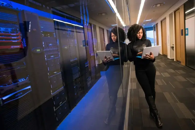 woman in black top using MacBook